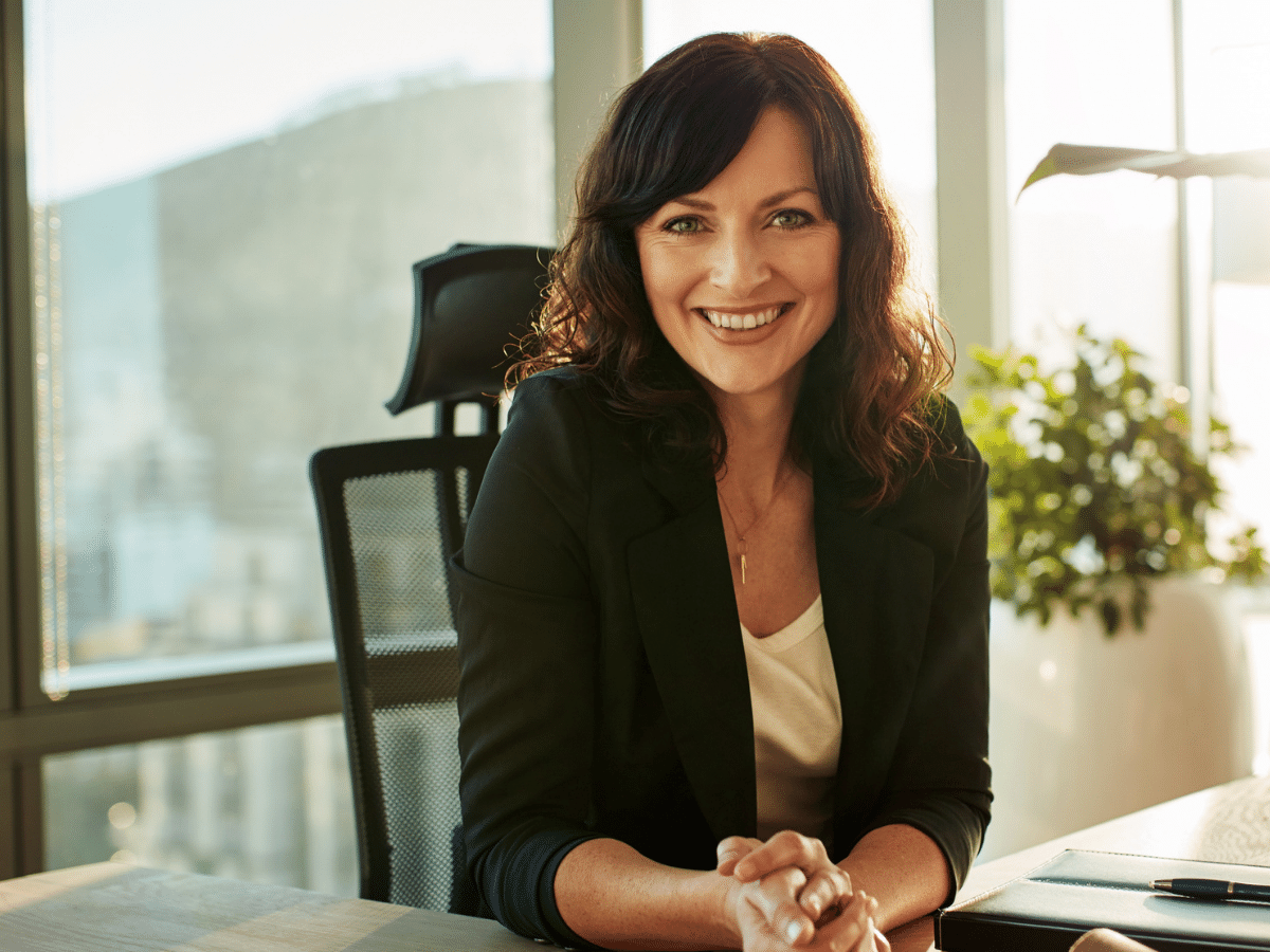 Woman sitting at her desk in business casual attire