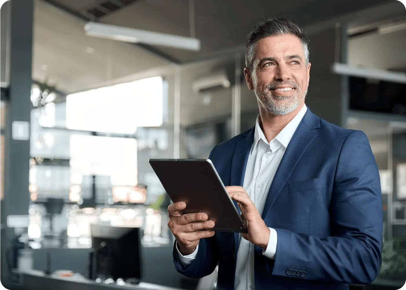 Man smiling while working on tablet