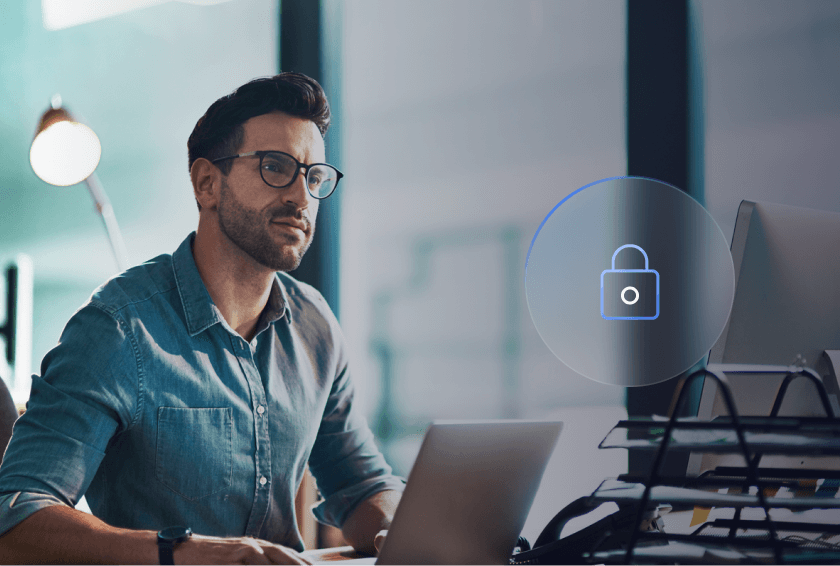 Man with glasses working on his laptop with circle icon with a lock in the middle representing email archive migration control