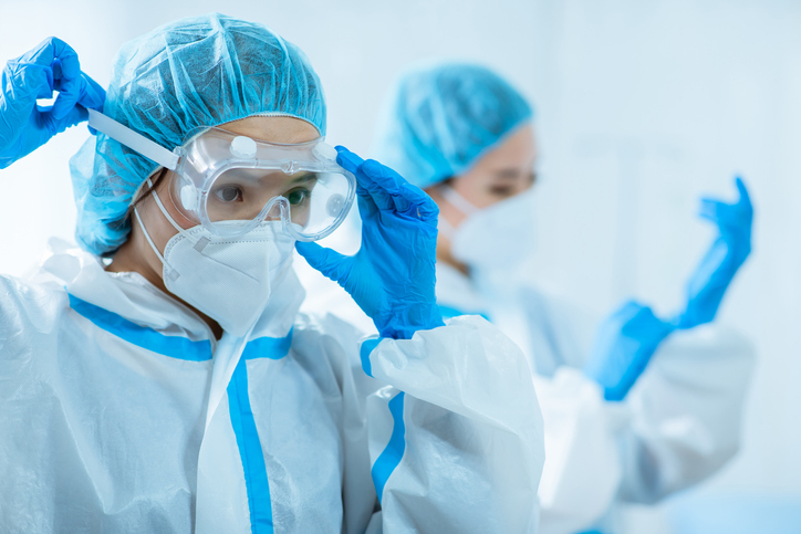 Two biomedical researchers in full gear
